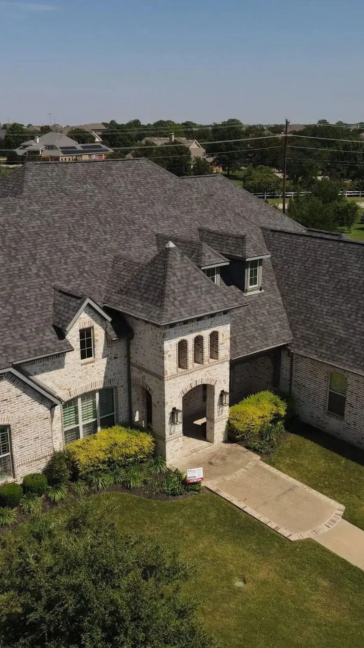 Drone view of a completed Roof Raiders roof in a DFW neighborhood