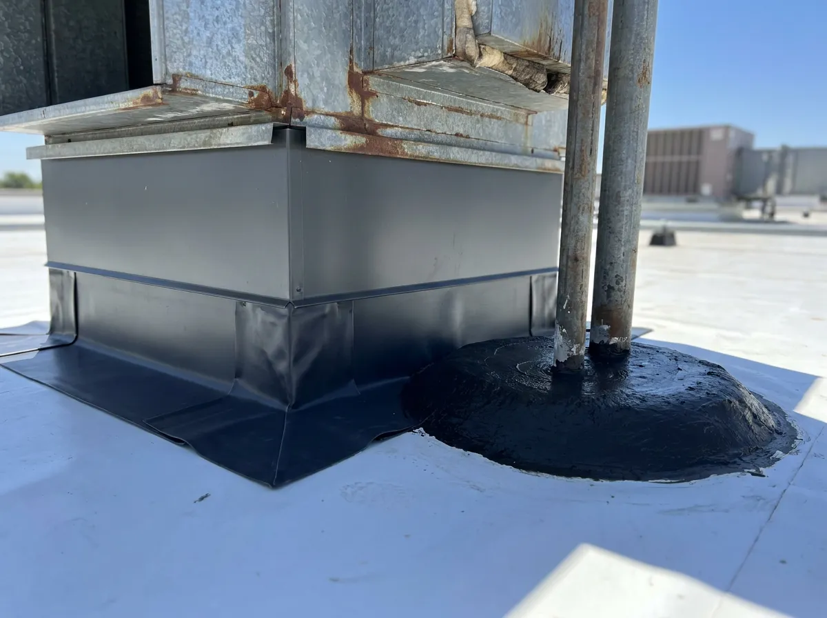 HVAC curb flashing with a fresh pitch pocket sealed on a commercial industrial roof