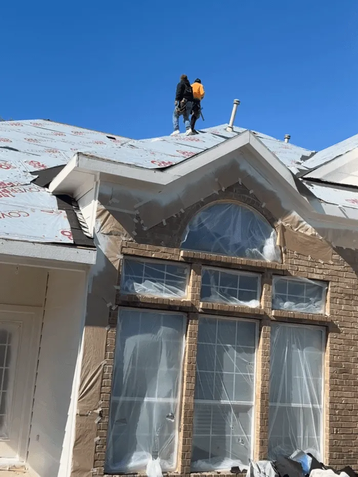Roof Raiders crew prepping a brick home for siding and window work