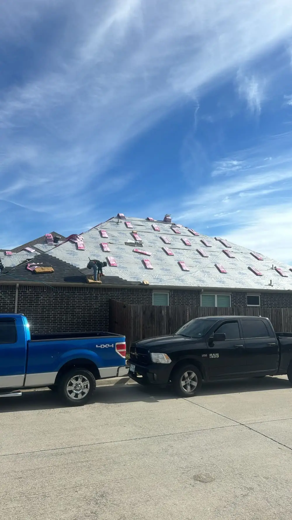 Shingle bundles loaded on the roof on install day as a Roof Raiders crew works a North Texas shingle replacement