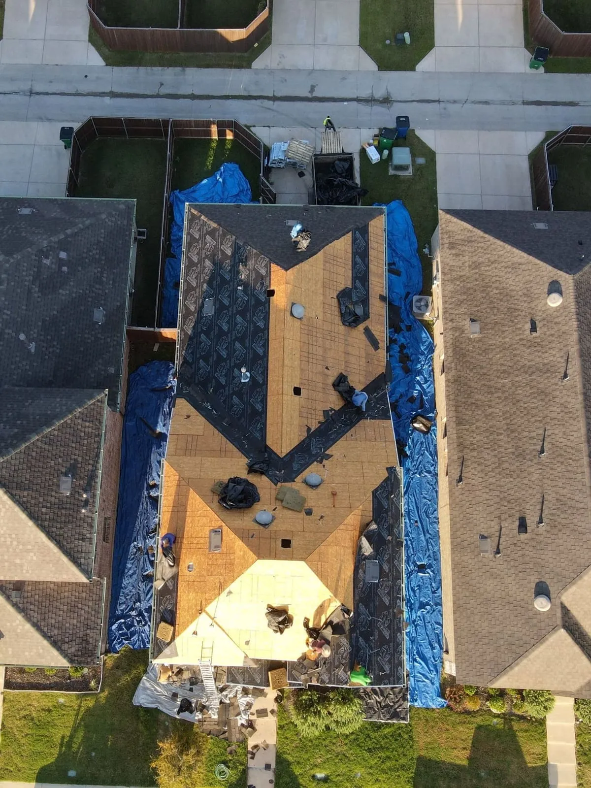 Blue tarps protecting a home during emergency storm response
